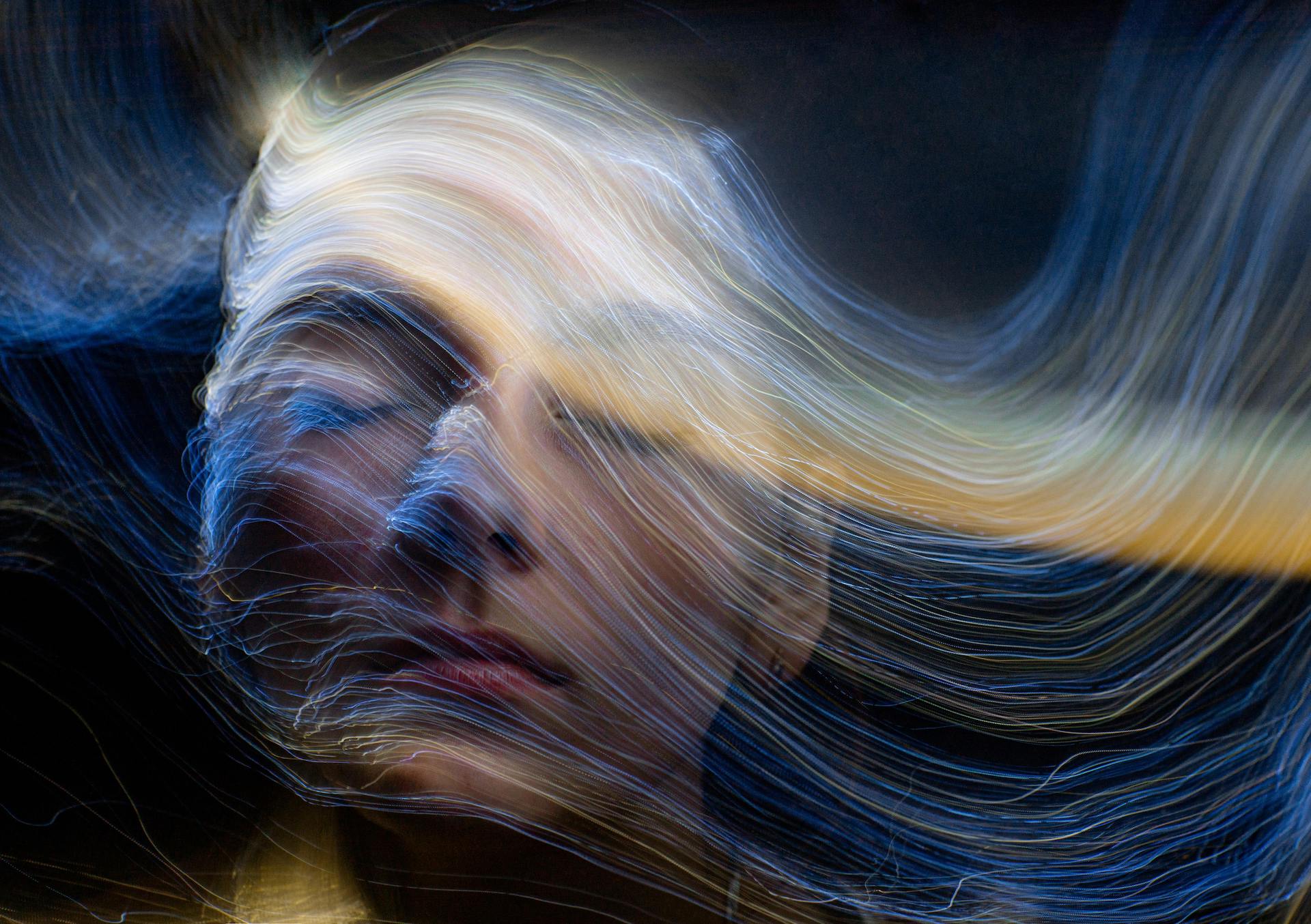 Abstract light painting with wavy lines on a dark background