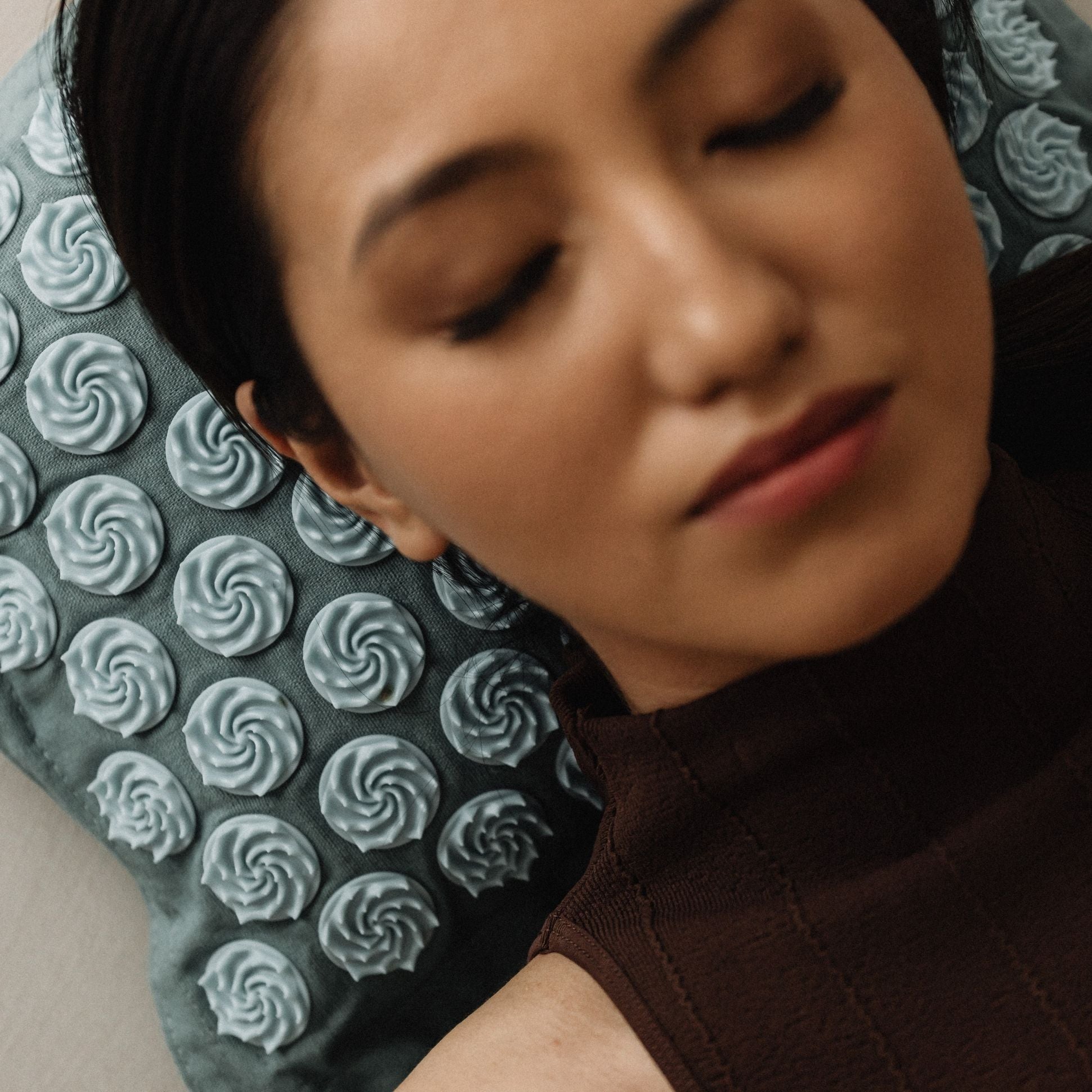 Person using a neck pillow with a textured pattern