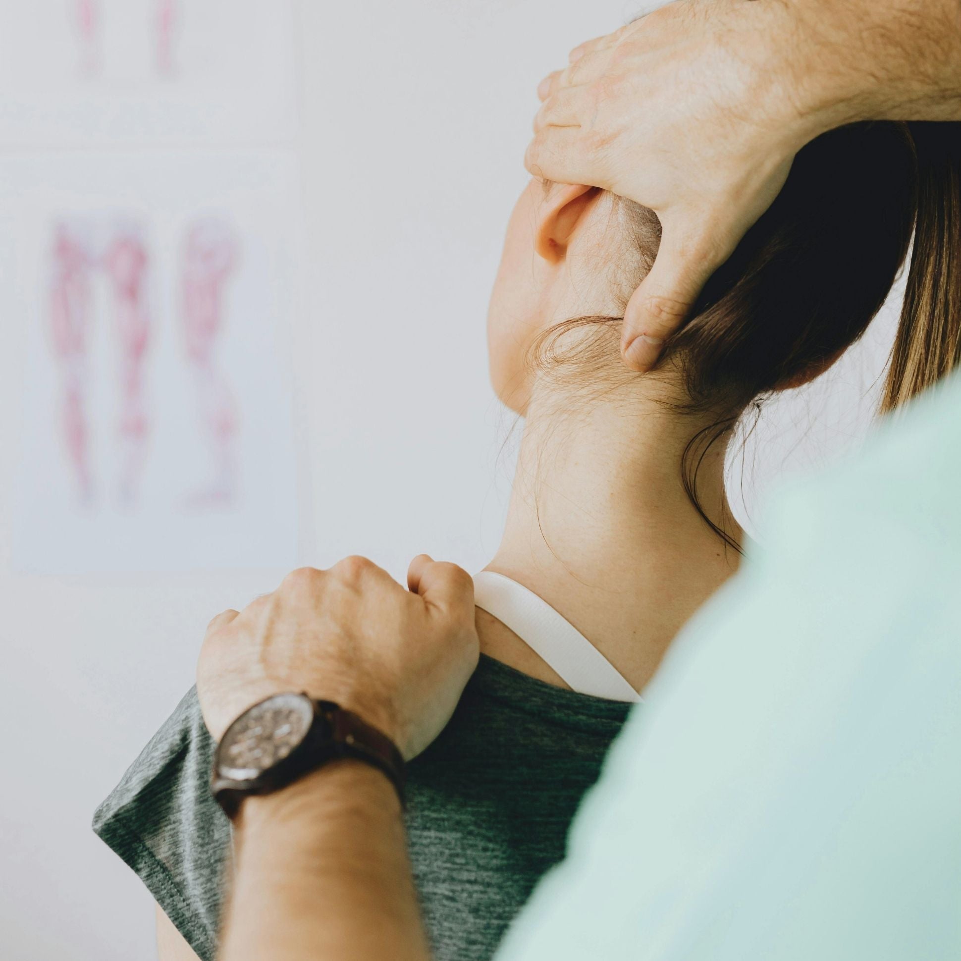 Person receiving a neck massage from another person with a blurred background